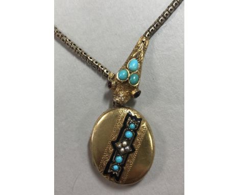 A 19th century gem set snake necklace and locket, the sinuous body of tubular links each with pierced star decoration, the te