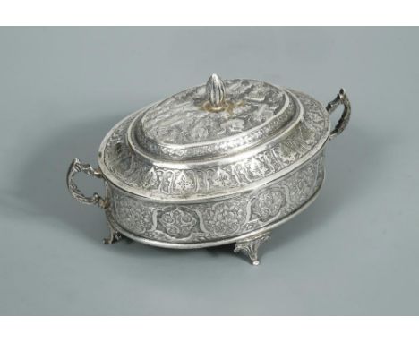 A Middle Eastern covered casket, of oval form, the sides heavily decorated with symmetrical engraving in the Middle Eastern s