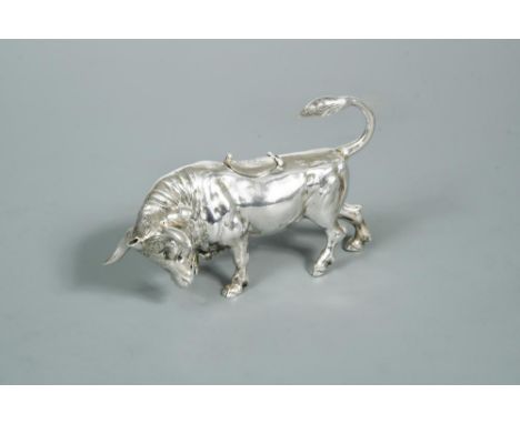 A continental bull in the style of a novelty cow creamer, the detailed cast body with hinged saddle decorated with a fly, the