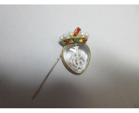 A reverse carved rock crystal pendant set with a coronet of gems and enamel, the heart shaped rock crystal cabochon with face