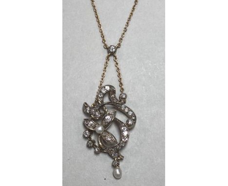 An early 20th century diamond and pearl pendant necklace, the belcher link chain joined at the front by an old round brillian