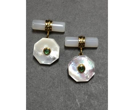 A pair of mother of pearl and emerald set cufflinks, each with one end formed by a hexagonal dished mother-of-pearl plaque se