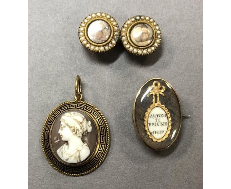 A trio of memento jewels, the first a short brooch composed of twin circular glazed panels containing plaited hair of differe