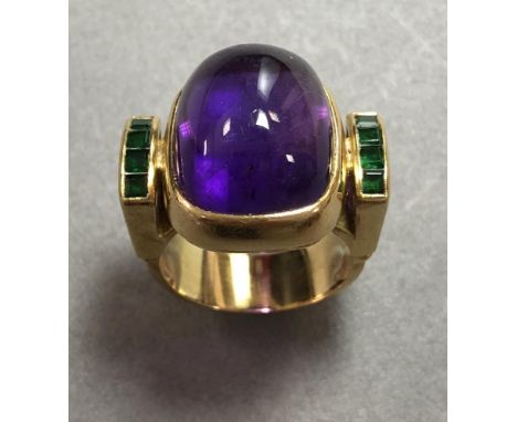 An 18ct gold, amethyst and green hardstone ring, the rectangular cushion shaped deep cabochon amethyst measuring 17 x 14mm, c