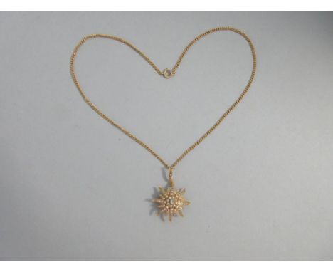 An antique diamond and seed pearl sunburst pendant / brooch with chain, with an old round cut diamond at the centre to a tier