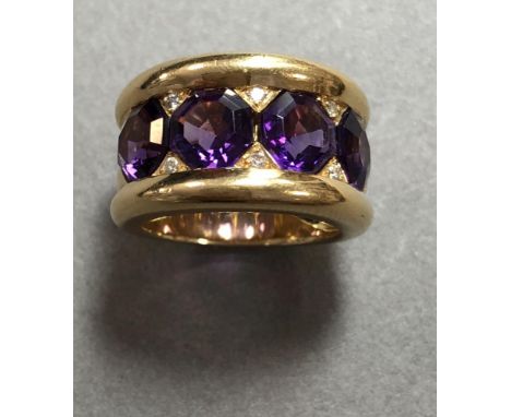 An unusual modern amethyst and diamond band ring set in 18ct gold, designed a a broad half hoop of four octagonal cut emperor