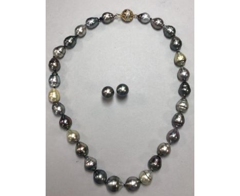A necklace and earstud suite of baroque cultured South Sea pearls in shades of grey, the twenty nine mostly pear-shaped and r