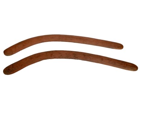 Two Australian aboriginal fighting boomerangs with light adzing to the surface, length 74cm and 72cm, sold with labels from t