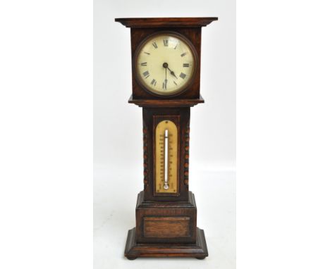 An early 20th century oak miniature longcase clock and thermometer, the cream circular dial set with Roman numerals and Arabi