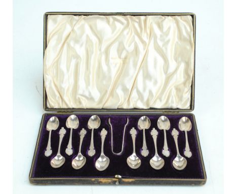 WALKER & HALL; a cased set of twelve George V hallmarked silver coffee spoons with foliate and scallop decorated finials init