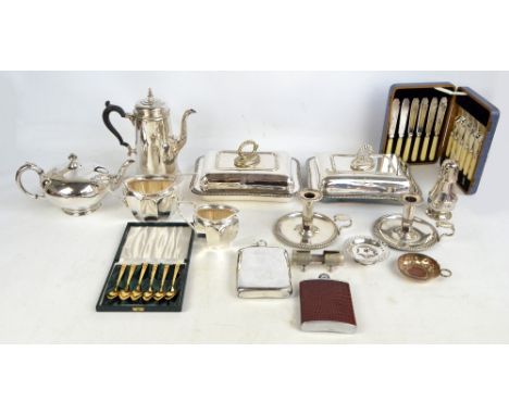 A group of electroplated items including a pair of entree dishes, a pair of chamber sticks and a squat globular teapot.