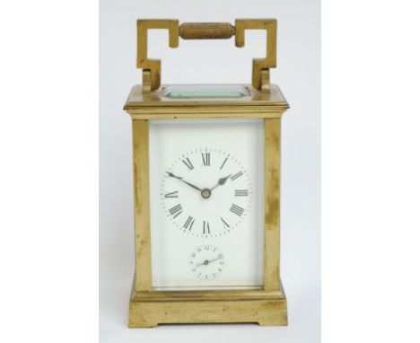 A circa 1900 brass carriage clock, the rectangular dial set with circular chapter ring with Roman numerals and with subsidiar
