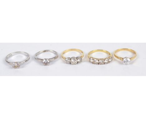 Two 14ct yellow gold and cubic zirconia set rings, size R, two 925 silver examples and a silver gilt example, gold approx 6g 