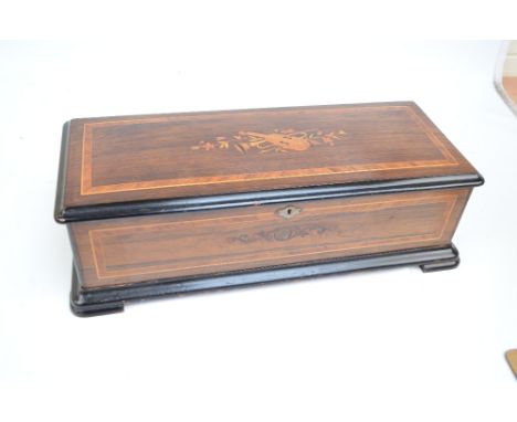 A 19th century Swiss lever wind musical box playing ten airs including Verdi, Suppé and Strauss, with chromolithograph tune s
