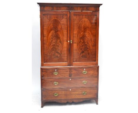 A 19th century mahogany linen press with pair of inlaid doors above two short and two long drawers, on bracket feet, width 12