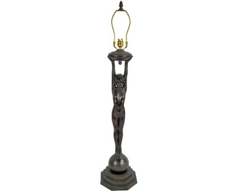 A reproduction Art Deco style spelter table lamp modelled as a nude female holding a torch aloft, height including brass fitm