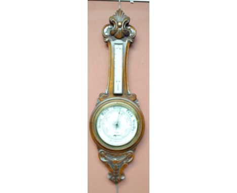 A carved oak banjo barometer beneath thermometer, length 88cm (glass af).   CONDITION REPORT:  Glass cracked at centre.
