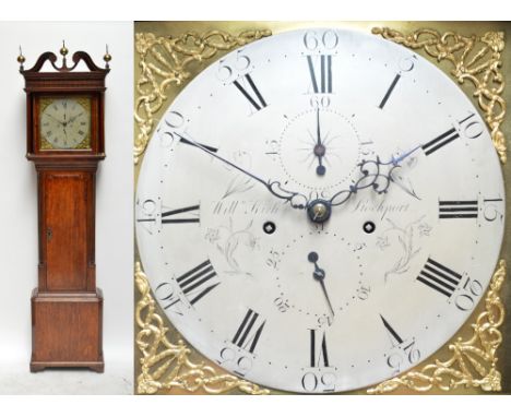 An early 19th century oak and mahogany crossbanded longcase clock, the broken swan neck pediment above circular silvered dial