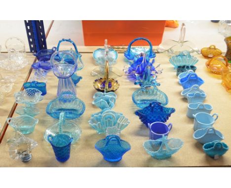 A collection of 19th and 20th century glass baskets including vaseline examples by Davidson, milk glass examples by Sowerby a