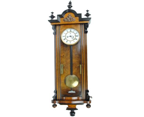 A large Victorian walnut and ebonised eight day twin weight Vienna wall clock, the circular enamel dial set with Roman numera
