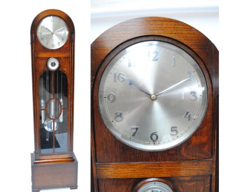 An early 20th century oak three weight longcase clock, the domed top above silvered circular dial set with Arabic numerals, w