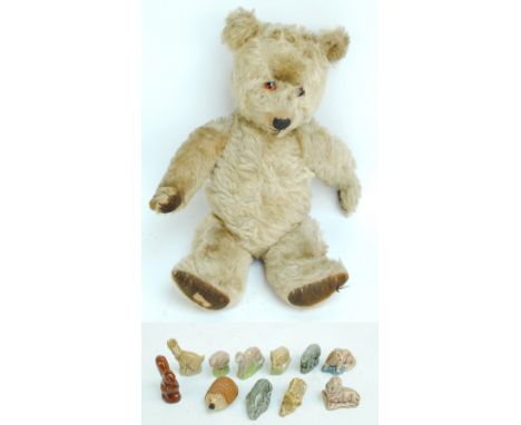 A 1950s straw stuffed musical teddy bear, height 45cm, also a small group of Wade animals.   CONDITION REPORT:  In order for 