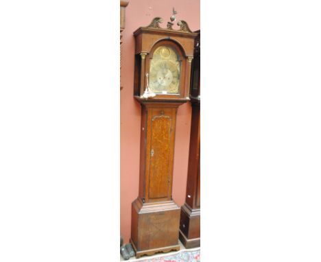 A late 18th century oak longcase clock, the broken swan neck with gilt metal detail above arched brass dial with circular cha