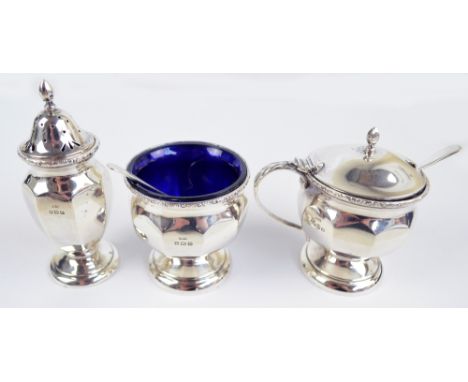 DOCKER & BURN LTD; a George III hallmarked silver three piece cruet set comprising a circular open faceted salt on spreading 