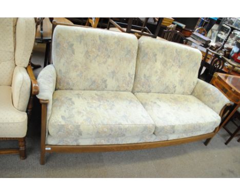 An Ercol three seater settee with padded arms and loose pads.