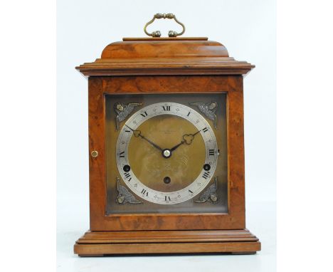 An Elliot burr walnut cased eight day lever Westminster and Whittington chime clock, the caddy top and stepped pediment above