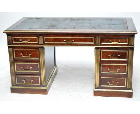 A French Empire Revival mahogany and brass set twin pedestal desk, the rectangular top with three frieze drawers and rectangu