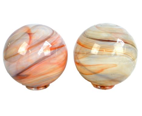 A pair of marbled effect glass globular light shades, diameter approx 25cm, diameter of lip aperture 10cm.