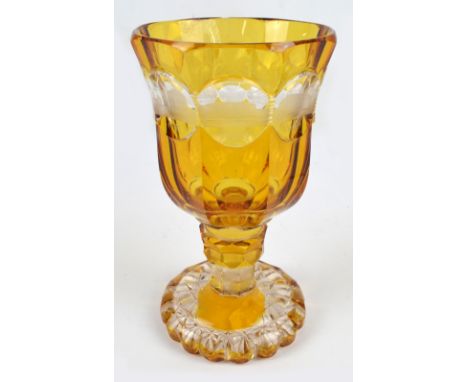 A circa 1900 Bohemian clear and amber tinted glass goblet of faceted bell shaped form, etched with architectural roundel to e