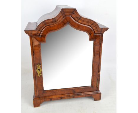 A late 19th century walnut veneered table top cabinet with single arched and mirrored door enclosing a formation of eleven va