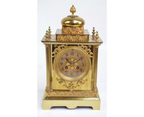 A late 19th century French brass eight day mantel clock with gilt metal foliate decorated globular top above similarly decora