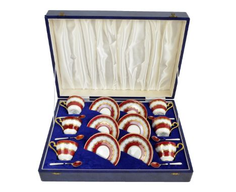 A cased Aynsley porcelain set of six coffee cans and saucers, pattern no.2494, with a set of six hallmarked silver gilt and g