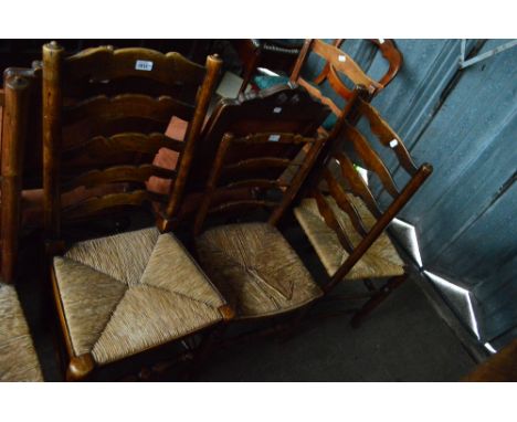 Three rush seated ladder back chairs and a plank seated ladder back chair (4).
