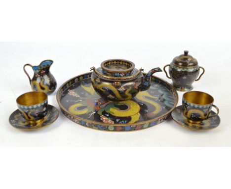 A Chinese six piece cloisonné tea set for two comprising a teapot, length 19.5cm including spout, a twin handled sugar bowl w