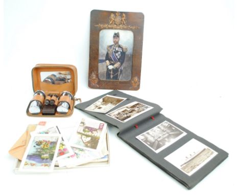 A collection of predominantly early 20th century real photo topographical postcards contained in an album, and a group of loo