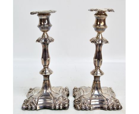 MARTIN, HALL & CO; a pair of Victorian hallmarked silver candlesticks with scallop decorated detachable sconces above foliate