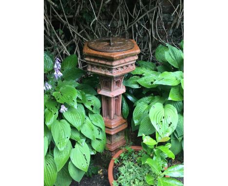 A reconstituted terracotta coloured sundial on Gothic hexagonal base, height approx 100cm.