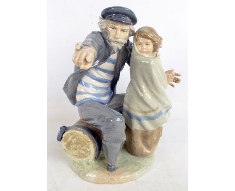 A large Nao figure group of a sailor and child, height 32.5cm (af).   CONDITION REPORT:  His pointing forefinger is broken bu