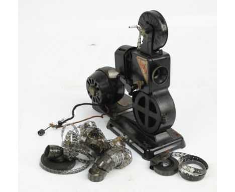 A Pathéscope 'Imp' home cinema projector and motor with surmounted Pathé 'Baby' canister and a small quantity of loose film r