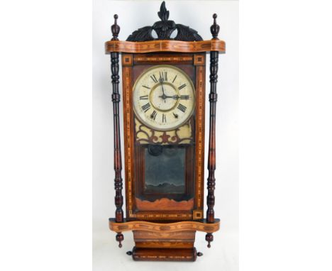 A late 19th/early 20th century American inlaid eight day chiming wall clock, the circular enamel dial set with Roman numerals