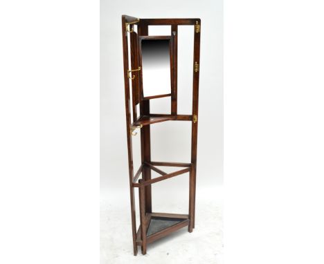 An oak corner hall stand with six brass pegs and swing mirror above small triangular platform with further pull-out platform/