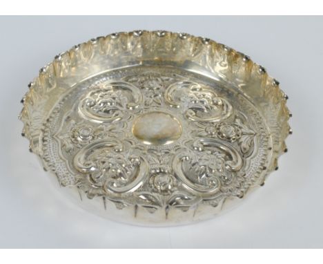 CHARLES EDWARDS; a Victorian hallmarked silver circular dish embossed with scrolls and floral motifs centred with a vacant ca