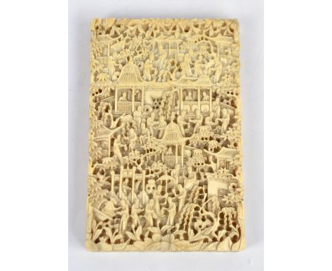 A 19th century Chinese Canton Export ivory card case of rectangular form elaborately carved with numerous figures in architec