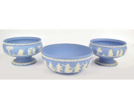 WEDGWOOD; a pair of light blue jasperware circular footed vases decorated with classical figures in landscape, diameter 22.5c
