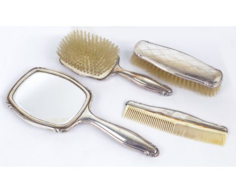 A Continental silver backed four piece dressing table set comprising a hand mirror, a hand brush, coat brush and a comb, silv