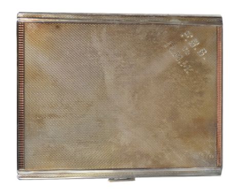 WILLIAM NEALE & SON LTD; a George VI hallmarked silver engine turned decorated rectangular cigarette case with rose gilt deta